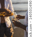 honeymoon couple drinking champagne on tropical beach 140501490