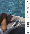 woman sunbathing by the pool 140501493