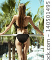 attractive woman in black bikini on summer vacation 140501495