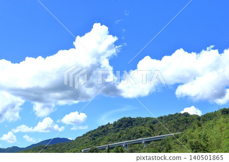 The Higashi-Hiroshima-Kure Expressway runs along the mountainside. 140501865
