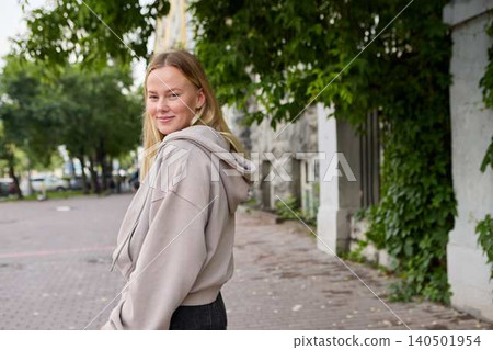 Young woman smiling in urban park alley Young woman smiling in urban park alley 140501954