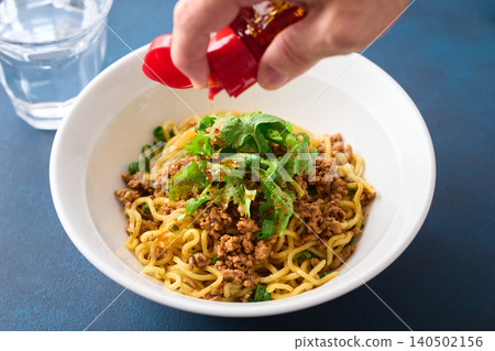Add chili oil to soupless dan dan noodles. Add chili oil to soupless dan dan noodles. 140502156