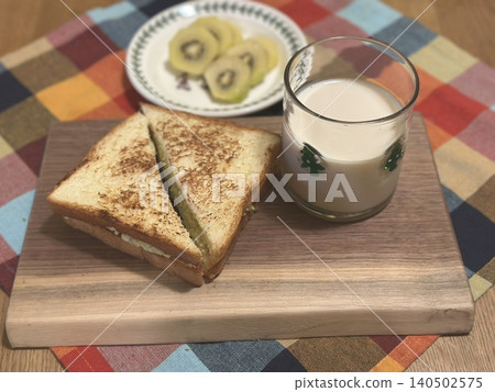 Golden, crispy toast topped with butter and jam, perfect for breakfast or snack-related projects. This image captures the warmth and comfort of a simple yet satisfying meal. Golden, crispy toast topped with butter and jam, perfect for breakfast or snack-related projects. This image captures the warmth and comfort of a simple yet satisfying meal. 140502575