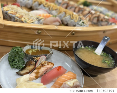 An assortment of fresh sushi, artfully arranged with a variety of toppings and vibrant colors. This traditional Japanese dish combines vinegared rice, seafood, and vegetables for an experience. An assortment of fresh sushi, artfully arranged with a variety of toppings and vibrant colors. This traditional Japanese dish combines vinegared rice, seafood, and vegetables for an experience. 140502594