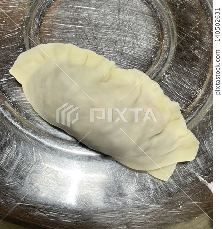 Korean dumplings filled with a mix of savory ingredients like ground meat, tofu, and vegetables. Mandu can be steamed, boiled, or pan-fried, making it a versatile and delicious snack or meal. Korean dumplings filled with a mix of savory ingredients like ground meat, tofu, and vegetables. Mandu can be steamed, boiled, or pan-fried, making it a versatile and delicious snack or meal. 140502631
