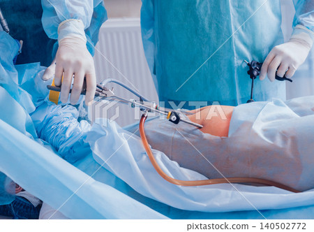 Process of gynecological surgery operation using laparoscopic equipment. Group of surgeons in operating room with surgery equipment Process of gynecological surgery operation using laparoscopic equipment. Group of surgeons in operating room with surgery equipment 140502772
