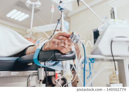 Pulse oximeter on the patient's hand Pulse oximeter on the patient's hand 140502774