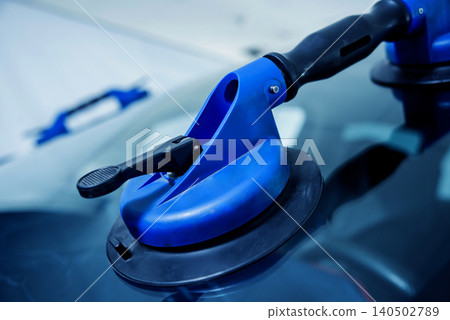 Automotive glazier equipment for replace windscreen. In auto service station garage. Automotive glazier equipment for replace windscreen. In auto service station garage. 140502789