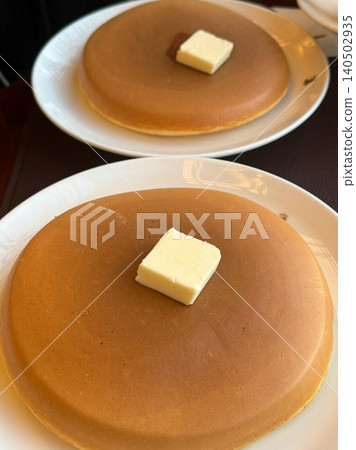 Fluffy and golden pancakes stacked high, served with syrup, butter, or fresh fruits. A warm and comforting breakfast classic that’s soft, sweet, and perfectly satisfying. 140502935