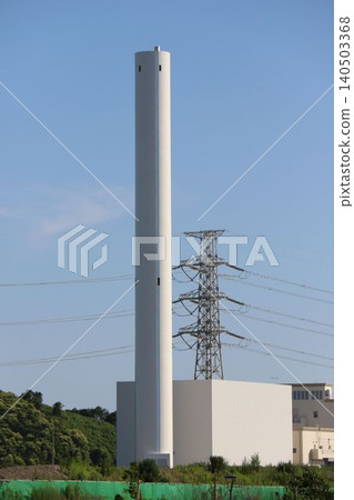 The white chimneys and power transmission towers of the Edogawa No. 1 Wastewater Treatment Plant stand tall against the blue sky. The white chimneys and power transmission towers of the Edogawa No. 1 Wastewater Treatment Plant stand tall against the blue sky. 140503368