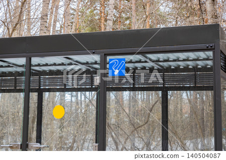 Modern Shelter with Transparent Walls Surrounded by Dense Forest, Featuring Functional Amenities and a Stylish Design for Visitor Comfort and Convenience Modern Shelter with Transparent Walls Surrounded by Dense Forest, Featuring Functional Amenities and a Stylish Design for Visitor Comfort and Convenience 140504087