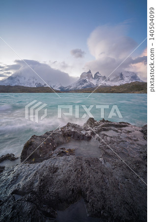 Patagonia mountain lake, snowy peak, turquoise water, rock shore, cloud sky Patagonia mountain lake, snowy peak, turquoise water, rock shore, cloud sky 140504099