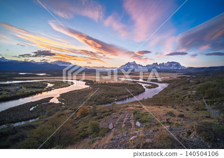 Patagonia river valley sunset landscape with mountain range and colorful sky Patagonia river valley sunset landscape with mountain range and colorful sky 140504106