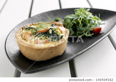 salmon and broccoli quiche with salad healthy meal on white cafe table salmon and broccoli quiche with salad healthy meal on white cafe table 140504582