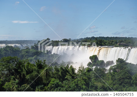 Majestic iguazu falls pouring huge waterfall into river surrounded by beautiful lush nature Majestic iguazu falls pouring huge waterfall into river surrounded by beautiful lush nature 140504755