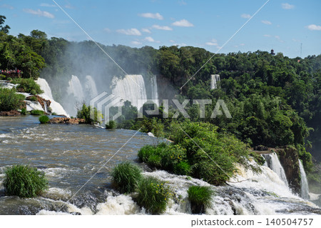 Breathtaking majestic iguazu falls waterfall landscape river flowing fast by lush green forest Breathtaking majestic iguazu falls waterfall landscape river flowing fast by lush green forest 140504757
