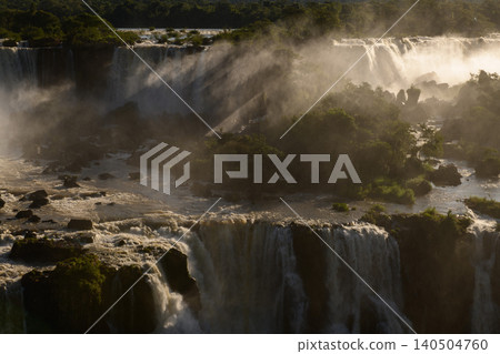 Dramatic iguazu falls cascading water through mist creating awe inspiring nature landscape Dramatic iguazu falls cascading water through mist creating awe inspiring nature landscape 140504760