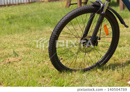 Modern MTB bicycle standing on a green lawn. Active lifestyle and sport concept Modern MTB bicycle standing on a green lawn. Active lifestyle and sport concept 140504789