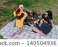 Father with three Children Celebrating a Dog's Birthday Picnic in the Park 140504936