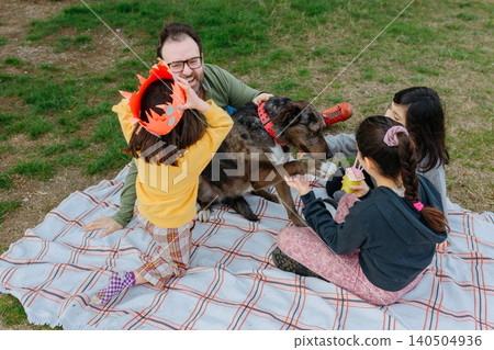 Father with three Children Celebrating a Dog's Birthday Picnic in the Park Father with three Children Celebrating a Dog's Birthday Picnic in the Park 140504936