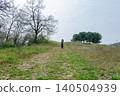 Child walking with stilts along a countryside trail 140504939