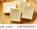 Dried freeze-dried tofu is piled up on a bamboo sieve. 140504941