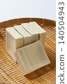 Dried freeze-dried tofu is piled up on a bamboo sieve. 140504943