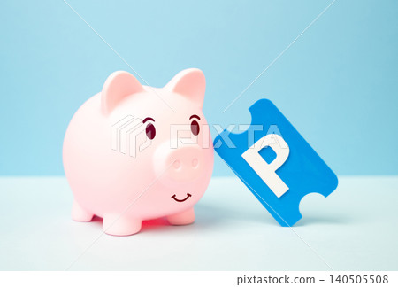 A piggy bank and a parking ticket. Saving on car parking. 140505508