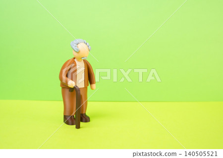 A grandfather and a place for dexterity. An elderly man with a cane. An old-fashioned suit. The older generation, the silent generation. A grandfather and a place for dexterity. An elderly man with a cane. An old-fashioned suit. The older generation, the silent generation. 140505521