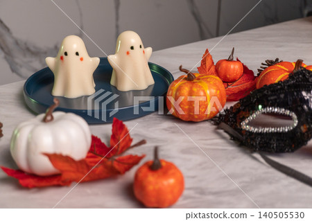 Halloween scene with ghost jellies and pumpkins on marble surface Halloween scene with ghost jellies and pumpkins on marble surface 140505530