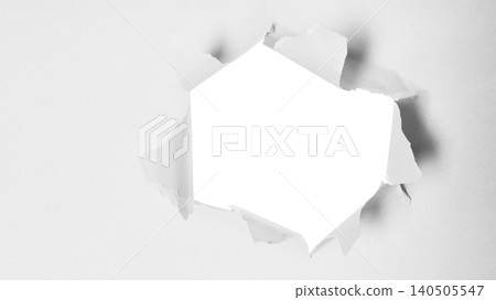 A Close-Up View of a Torn Hole in a White Wall with Frayed Edges and Visible Texture Elements A Close-Up View of a Torn Hole in a White Wall with Frayed Edges and Visible Texture Elements 140505547