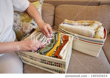 Organizing Fabrics and Textiles in a Cozy Living Space with Neat Baskets and Folded Cloths 140505654