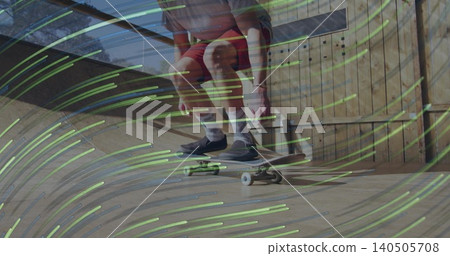 Crouching skater wearing red shorts riding skateboard on wood ramp at home, watch and green streaks Crouching skater wearing red shorts riding skateboard on wood ramp at home, watch and green streaks 140505708
