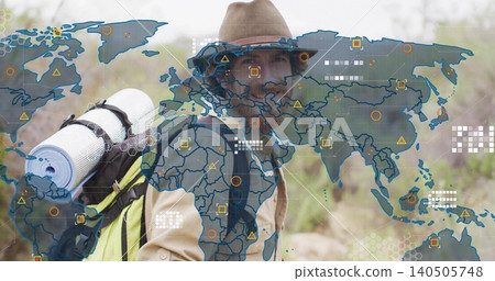 Standing hiker wearing brimmed hat tan-jacket at dry trail with yellow-pack rolled-pad and map-ui Standing hiker wearing brimmed hat tan-jacket at dry trail with yellow-pack rolled-pad and map-ui 140505748