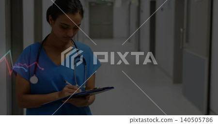 Writing nurse in hospital corridor, blue scrubs with stethoscope holding clipboard, pen, copy space Writing nurse in hospital corridor, blue scrubs with stethoscope holding clipboard, pen, copy space 140505786