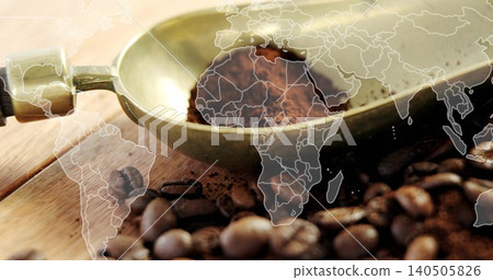 Displaying brass coffee scoop holding ground coffee on wooden tabletop, showing world map overlay Displaying brass coffee scoop holding ground coffee on wooden tabletop, showing world map overlay 140505826