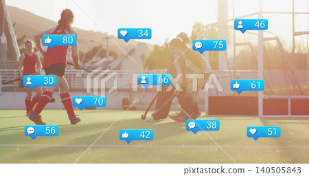 Contesting teenage hockey players in red, light uniforms vying for ball on turf, sticks, blue icons Contesting teenage hockey players in red, light uniforms vying for ball on turf, sticks, blue icons 140505843