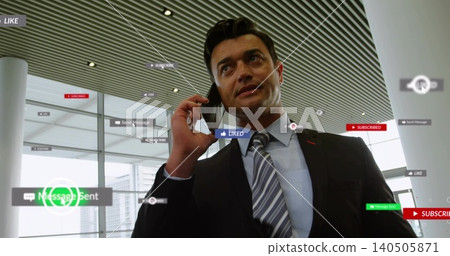 Standing suited executive with striped-tie holding phone to ear in atrium, with floating overlays Standing suited executive with striped-tie holding phone to ear in atrium, with floating overlays 140505871