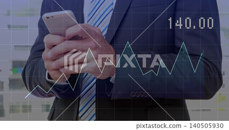 Holding smartphone, businessman checking phone in office, navy suit and striped tie, chart 140 140505930