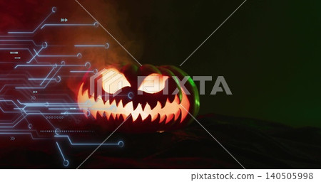 Glowing carved pumpkin casting warm light on dark cloth, rising smoke with blue circuit, copy space 140505998