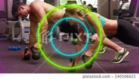 Performing kettlebell plank rows at gym, woman in teal sports bra and shirtless man, neon overlays Performing kettlebell plank rows at gym, woman in teal sports bra and shirtless man, neon overlays 140506025