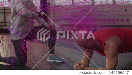 Coaching kneeling partner assisting plank-holding man wearing red top at gym, with magenta overlay Coaching kneeling partner assisting plank-holding man wearing red top at gym, with magenta overlay 140506047