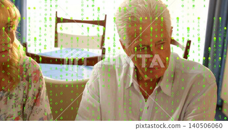 Sitting senior man in light shirt talking at home table, with blue tablecloth, green binary overlay Sitting senior man in light shirt talking at home table, with blue tablecloth, green binary overlay 140506060