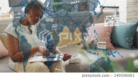 Writing senior woman holding clipboard and pen on sofa at home, handset and digital map overlay Writing senior woman holding clipboard and pen on sofa at home, handset and digital map overlay 140506061