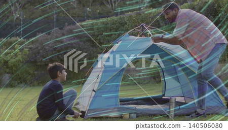 Assembling man in checked shirt, jeans adjusting tent in yard, boy holding peg, sleeping bag Assembling man in checked shirt, jeans adjusting tent in yard, boy holding peg, sleeping bag 140506080