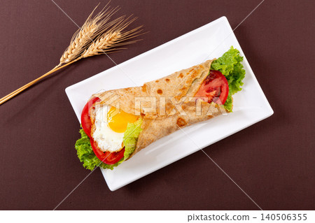 Whole Wheat Wrap with Fried Egg, Lettuce and Tomato, Healthy Breakfast Whole Wheat Wrap with Fried Egg, Lettuce and Tomato, Healthy Breakfast 140506355