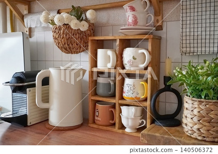 Charming Kitchen Display Featuring Colorful Mugs, Elegant Teapot, and Whimsical Decor Accents Charming Kitchen Display Featuring Colorful Mugs, Elegant Teapot, and Whimsical Decor Accents 140506372