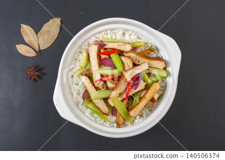 Chinese Claypot Rice with Smoked Tofu, Celery and Chili. Traditional Cantonese Sizzling Rice Bowl, Asian Comfort Food. Chinese Claypot Rice with Smoked Tofu, Celery and Chili. Traditional Cantonese Sizzling Rice Bowl, Asian Comfort Food. 140506374