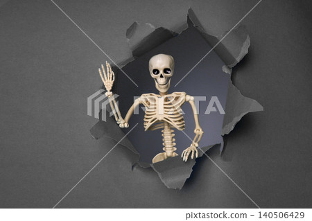 Skeleton Emerging from a Broken Wall with a Playful Gesture in a Dark Background Setting Skeleton Emerging from a Broken Wall with a Playful Gesture in a Dark Background Setting 140506429
