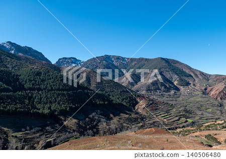 Vast view of the Atlas Mountains with terraced fields near a remote Moroccan village. Vast view of the Atlas Mountains with terraced fields near a remote Moroccan village. 140506480